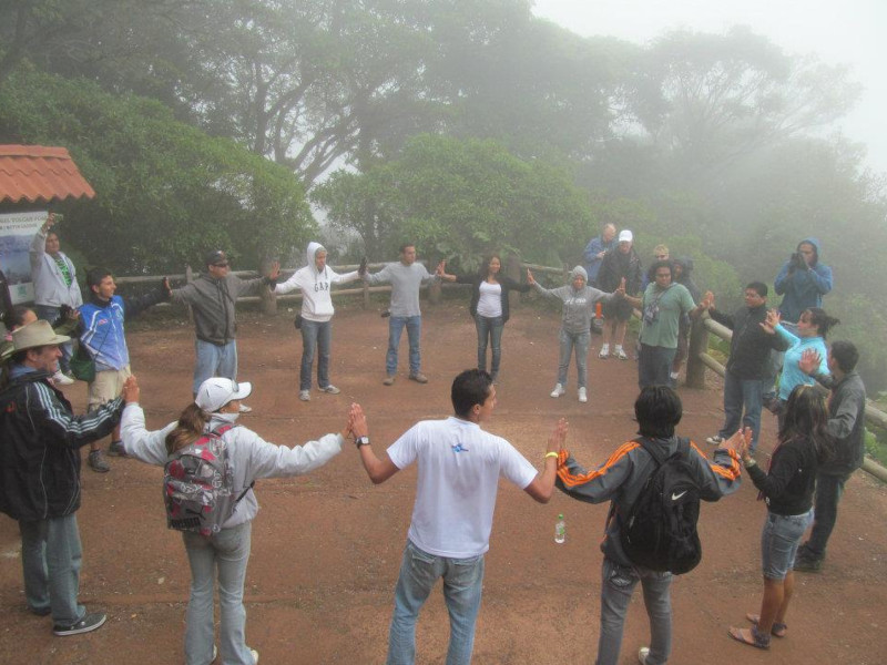 Picture of a round people sharing a good time, holding their hands